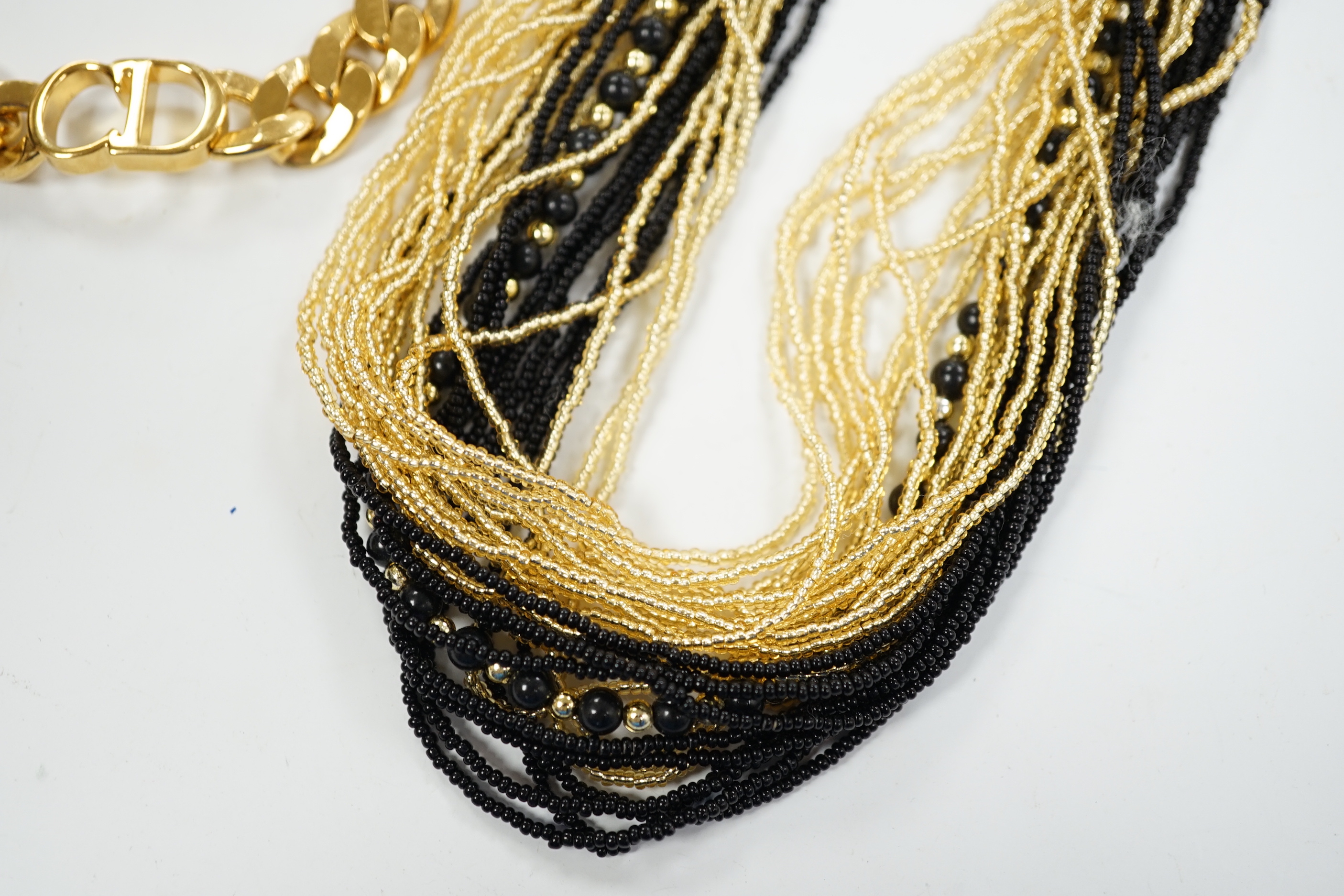A Christian Dior Danseuse Etoile gilt bracelet, 18cm, with Dior box and pamphlet etc. together with a Luciani Murano glass bead twist necklace, 48cm.